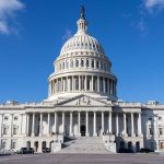 Capitol Police Apprehend Armed Suspect at U.S. Capitol, Highlighting Security Threats and Protocols U.S. Capitol building under a clear blue sky.