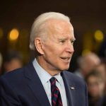 Trump’s Reversal of Biden’s Offshore Drilling Ban: Implications for Energy Policy and Environmental Conservation Elderly man in suit with crowd in background.