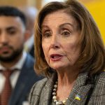 Political Family Feuds: Pelosi’s Daughter Challenges Jill Biden Amid Tensions Woman speaking; man blurred in background.