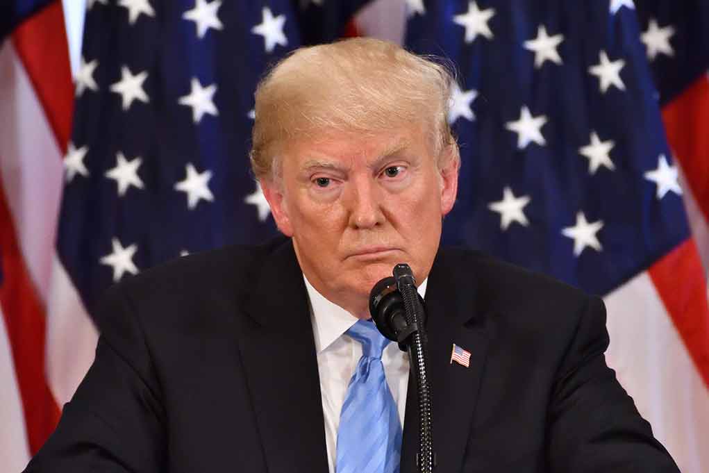 1191272251 featured image Man speaking at a podium with American flags.