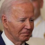 ICE Arrest Data Allegedly Manipulated By Biden’s DHS Man in a suit looking thoughtful.