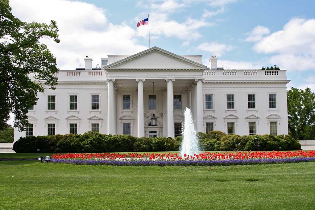 71114719 featured image White building with fountain and flower garden front