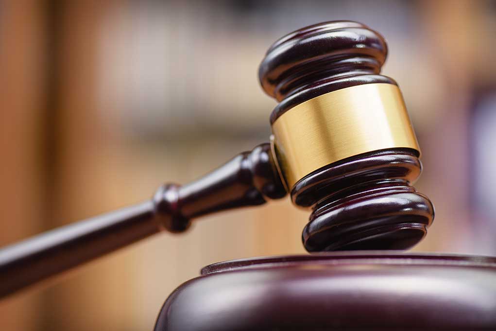 1334292137 featured image Wooden gavel on sound block courtroom setting