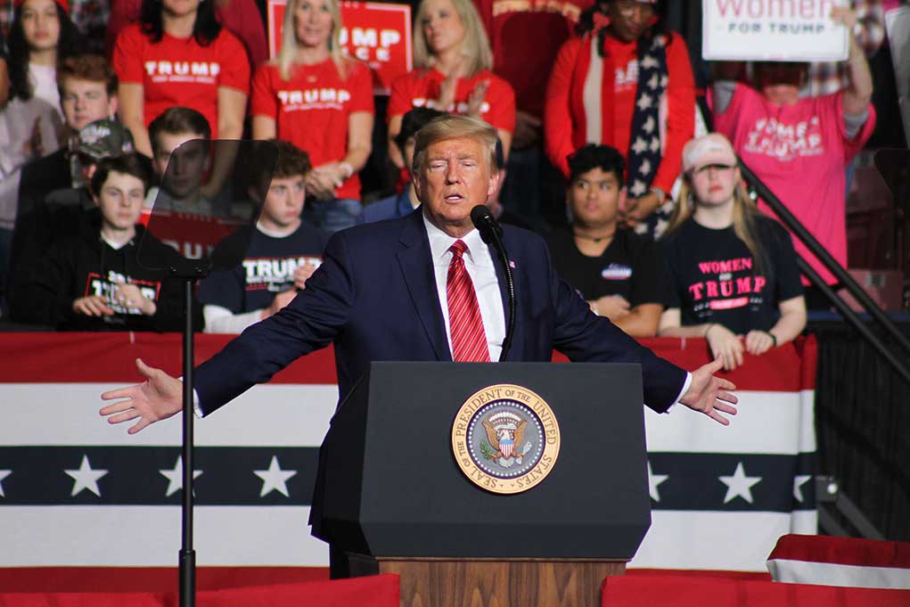 1662925921 featured image Person speaking at podium with crowd behind them