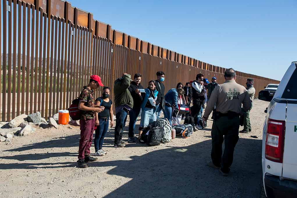 1973414822 featured image Group of people at border wall with patrol agents
