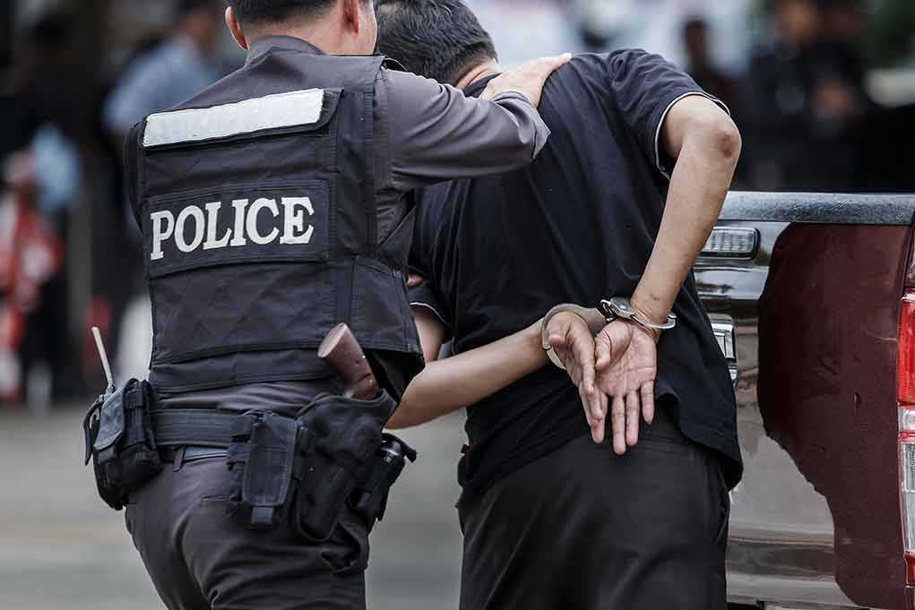693957643 featured image Police officer arrests handcuffed person