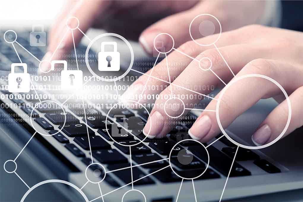 1158805660 featured image Hands typing with cybersecurity icons overlay.