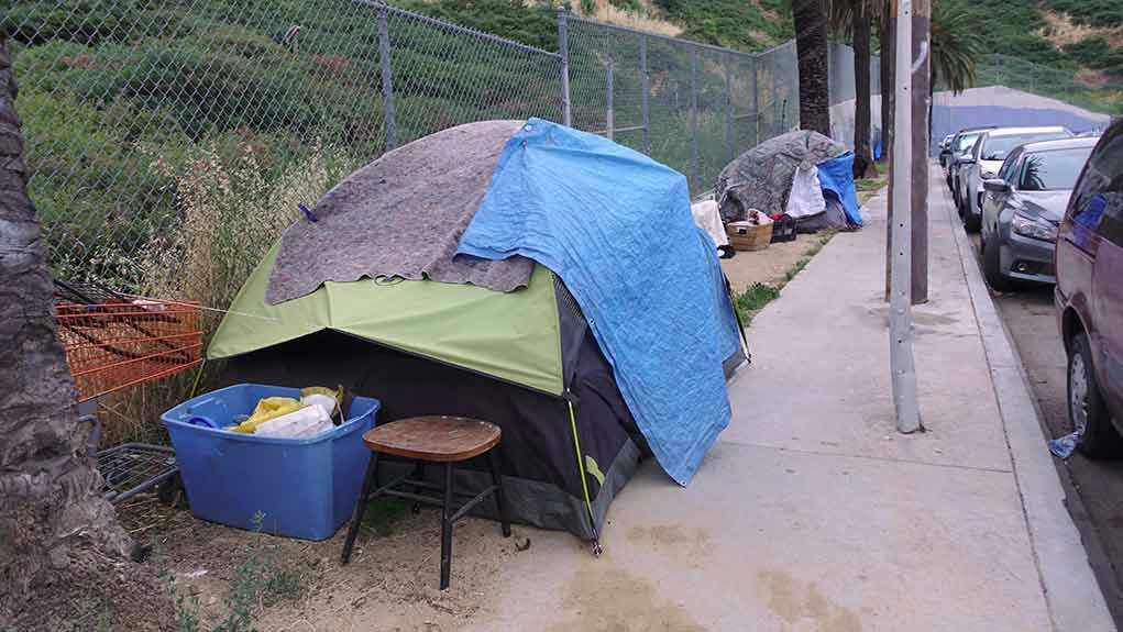 Tents and belongings set up along sidewalk