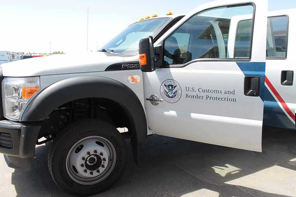 1434041024 U.S. Customs and Border Protection truck with open door.