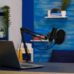 Meta’s Botched Ban Sparks Outrage Laptop and a microphone on a desk