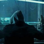 Child Crime Sting Nabs Top Israeli Cyber Chief Hacker in hoodie arrested at computer desk.