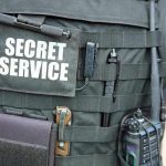 TERROR Plot Exposed: NYC Towers Targeted! Secret Service vest with various tactical gear attached.