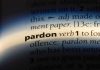 TRUMP PARDONS Billionaire Bro – Nation Stunned! The word pardon highlighted in a dictionary.