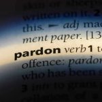 TRUMP PARDONS Billionaire Bro – Nation Stunned! The word pardon highlighted in a dictionary.