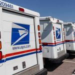 Bomb Squad Storms USPS—Suspect Packages Mailed! Row of USPS mail trucks parked in lot.