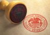 Fed Reserve CUTS Rates – Shock Vote Divides Federal Reserve stamp and wooden stamp on paper