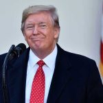 Trump’s Pick Triggers GOP Panic—What’s Coming? Man in suit and tie speaking at podium.