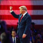 Dem Senator STUNS D.C. With Trump Praise – Wow! Person in suit with fist raised in front of flag.