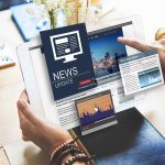 Person reading digital news on a tablet device