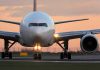 Airline GROUNDS Flights – Nationwide Halt! Airplane on runway during sunset.