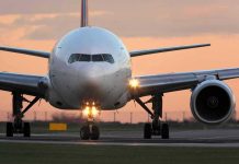 Airline GROUNDS Flights – Nationwide Halt! Airplane on runway during sunset.