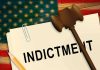 A legal document labeled 'INDICTMENT' with a gavel and pencil