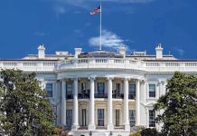 White House Bombshell: Congressman’s Intimidate Pics LEAKED! The White House with the American flag flying against a blue sky