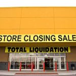 Grocery EMPIRE COLLAPSES — All Stores CLOSING! Exterior of a store with a large sign announcing a closing sale and total liquidation