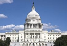 GOP Rep SUED – Stunning Accusations Rock Congress! U.S. Capitol building against blue sky.
