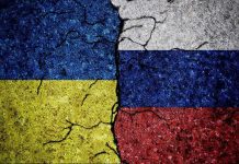Ukraine Bombs Moscow – Nobody Saw This Coming Cracked Ukrainian and Russian flags painted on concrete.