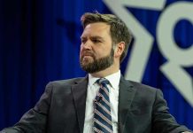 Vance THREATENS Republicans Over Trump Agenda Man in a suit with a thoughtful expression.