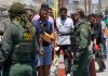 DHS UNLEASHES Military-Style Immigration Blitz – 200 Arrested! Border patrol agents inspecting group of individuals in line.
