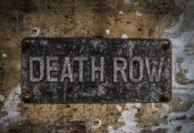 Execution Halted—Governor’s Move Shocks State Weathered Death Row sign on aged concrete wall