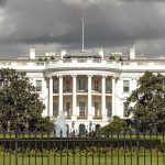 $50 Million Bounty Blitz – White House Issues Reward The White House with overcast sky and flag raised.