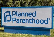 Planned Parenthood sign on a grassy lawn.