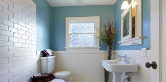 Modern bathroom with blue walls and white fixtures