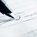 Scandal Erupts – Trump’s SUSPICIOUS Pardon Signatures Close-up of a pen poised above a document with handwritten lines