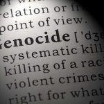 SHOCKING Civilian Massacre — 300 Dead Overnight Close-up of the word 'Genocide' in a dictionary with its definition
