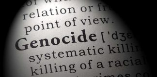 Close-up of the word 'Genocide' in a dictionary with its definition