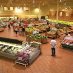 Grocery Giants Flee Socialist City: What’s Behind It? Interior of a grocery store filled with fresh produce and shoppers