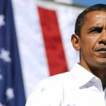 Obama’s Shocking Endorsement Snub – Nobody Expected This A man in a white shirt standing in front of an American flag