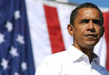 Obama’s Shocking Endorsement Snub – Nobody Expected This A man in a white shirt standing in front of an American flag