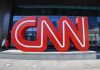 CNN’s Shocking Slip: Racial Mislabeling Chaos Large red CNN sign outside building entrance.