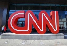 CNN’s Shocking Slip: Racial Mislabeling Chaos Large red CNN sign outside building entrance.