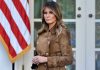 Putin HUMILIATES Trump – Melania Steps In Woman in brown coat beside American flag.