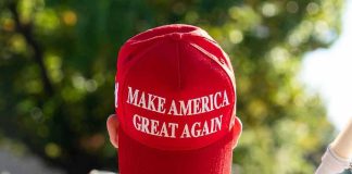 Person wearing a red Make America Great Again hat.