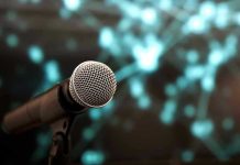 Microphone with abstract, blurred blue background.