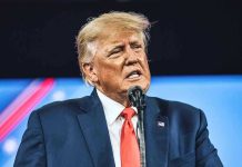 Trump’s Savage Congresswoman Takedown Stuns Political World Man in suit speaking at a microphone.