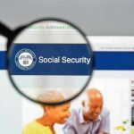 Magnifying glass focusing on Social Security Administration webpage.