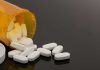 First Weight Loss Pill Approved – FDA’s SHOCKING Move Spilled prescription bottle with white pills.